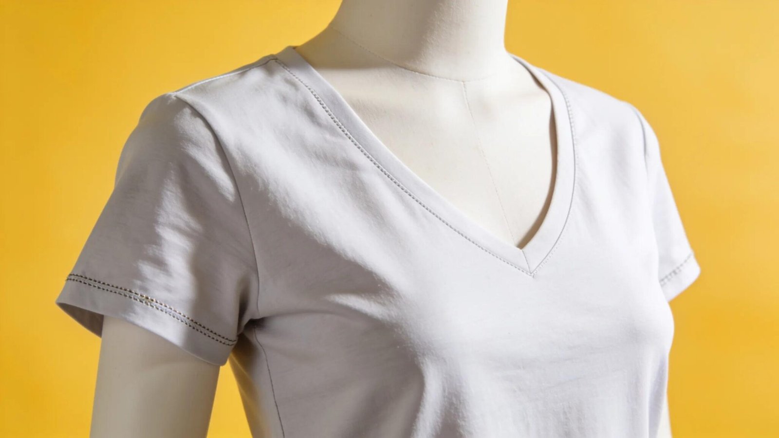 Stylish women's V-neck tee on a mannequin in a bright setting, highlighting comfort and versatility